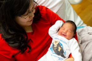 Baby in ANMC onesie encouraging vaccination